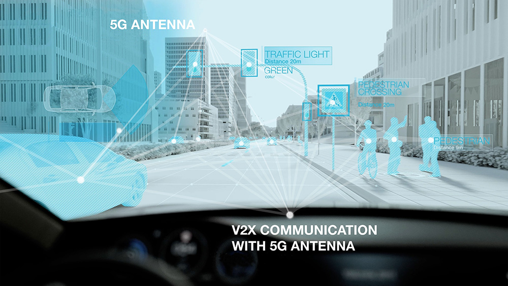 Vehicle driving down a street illustrating V2X Communication with 5G Antenna sensing people and objects