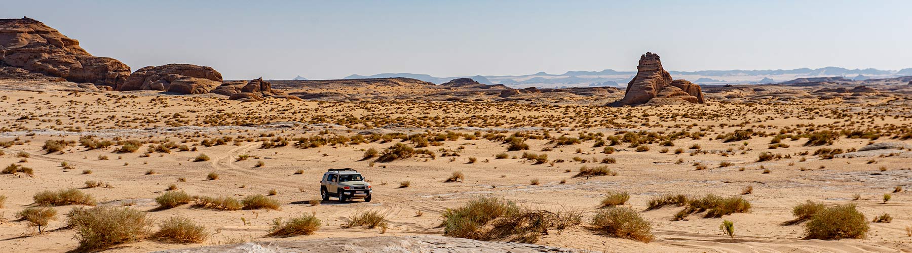 Vehicle driving through a desert