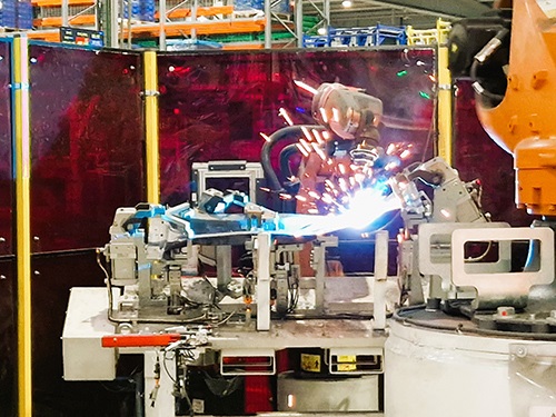 Robot welding an automotive part