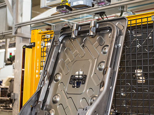 Frame of a vehicle bucket seat in a manufacturing facility