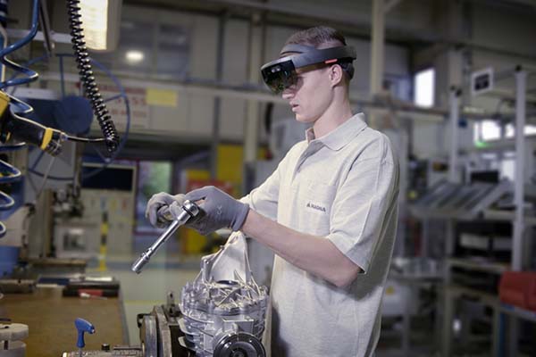 Person holding a ratchet in a manufacturing facility