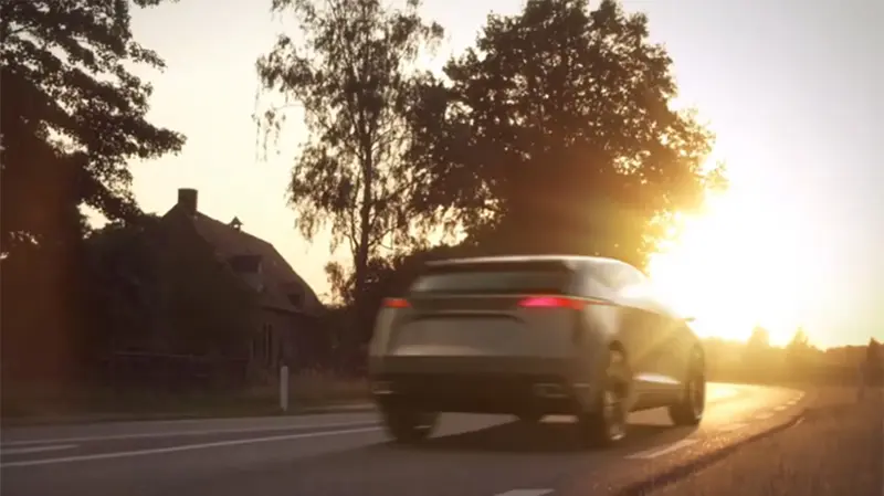 Vehicle driving along a winding road during the sunset