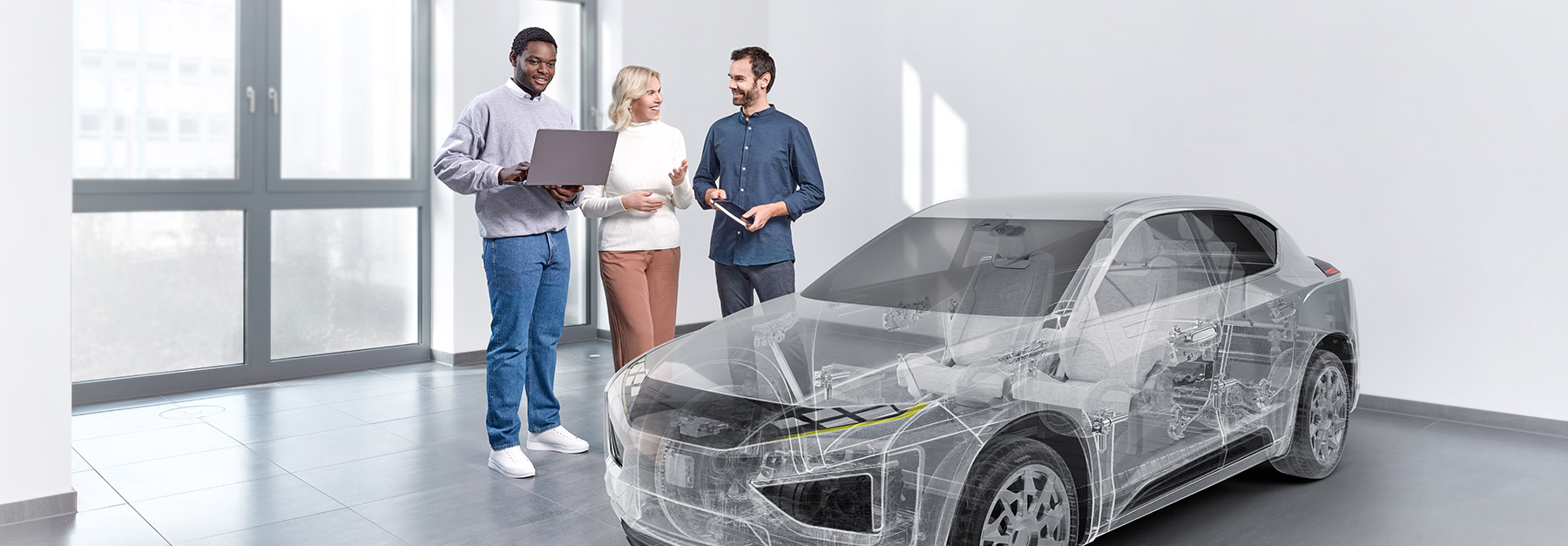 Group of people with a laptop standing beside a ghosted vehicle in a showroom