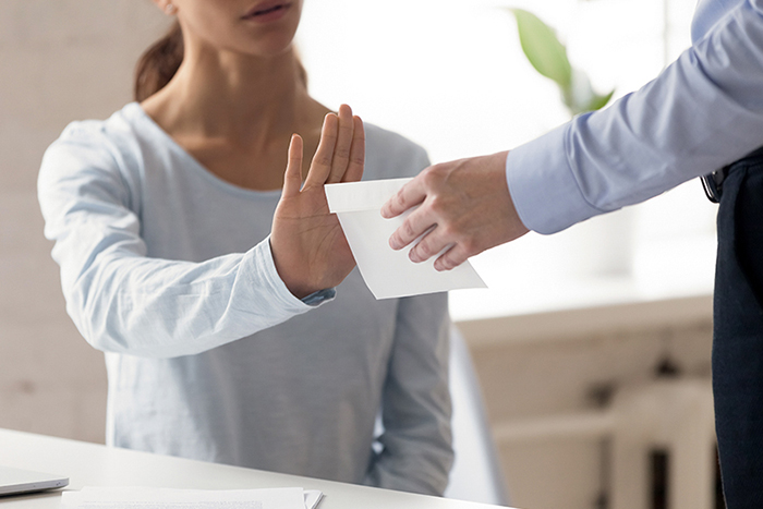 Two people sitting at a conference table in an office conducting an interview.