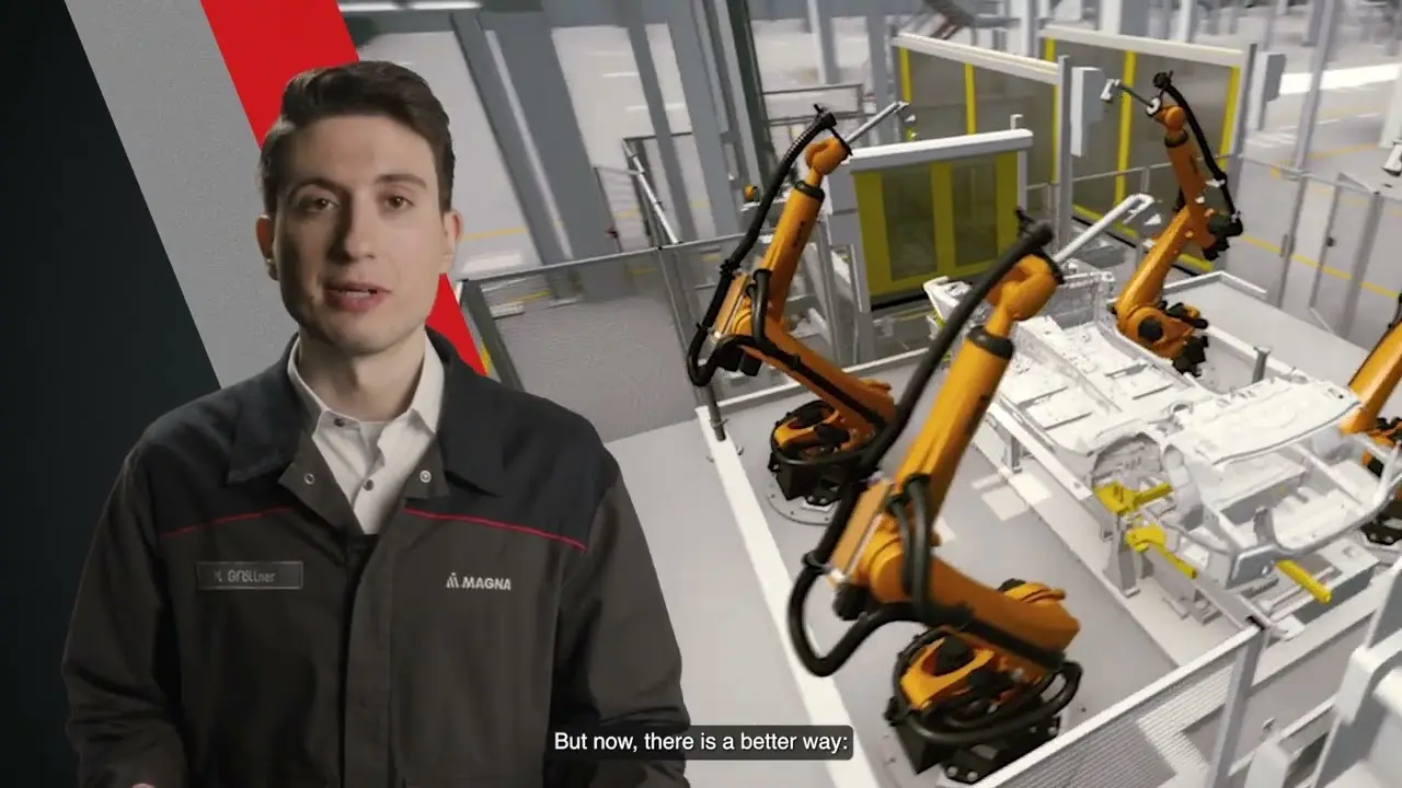 Technician explaining in front of a robotic assembly line in a factory setting