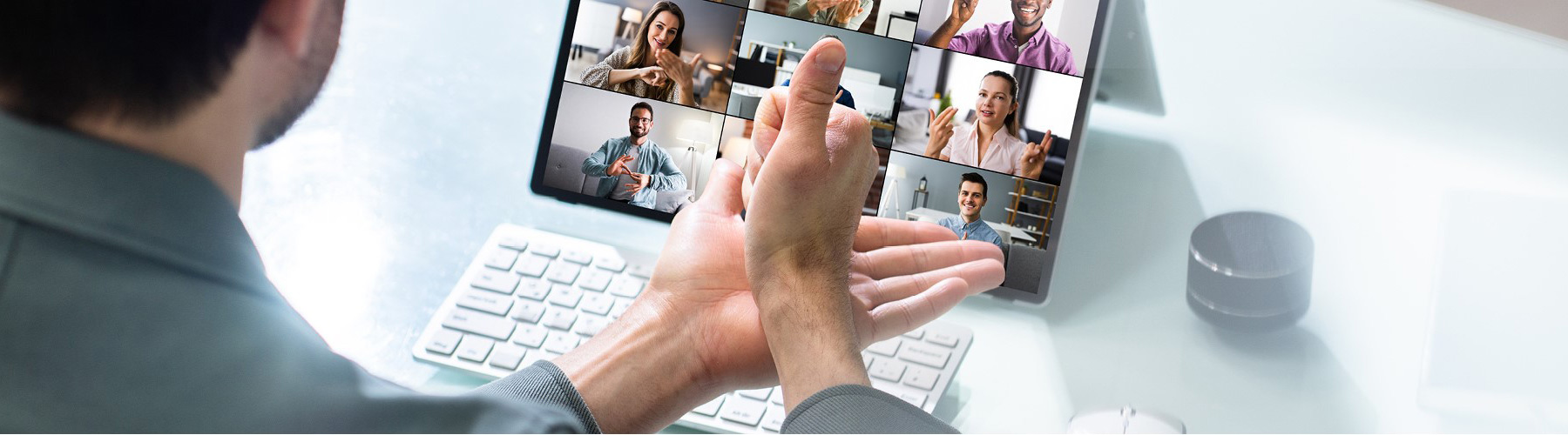 A person in a zoom meeting communicating using sign language