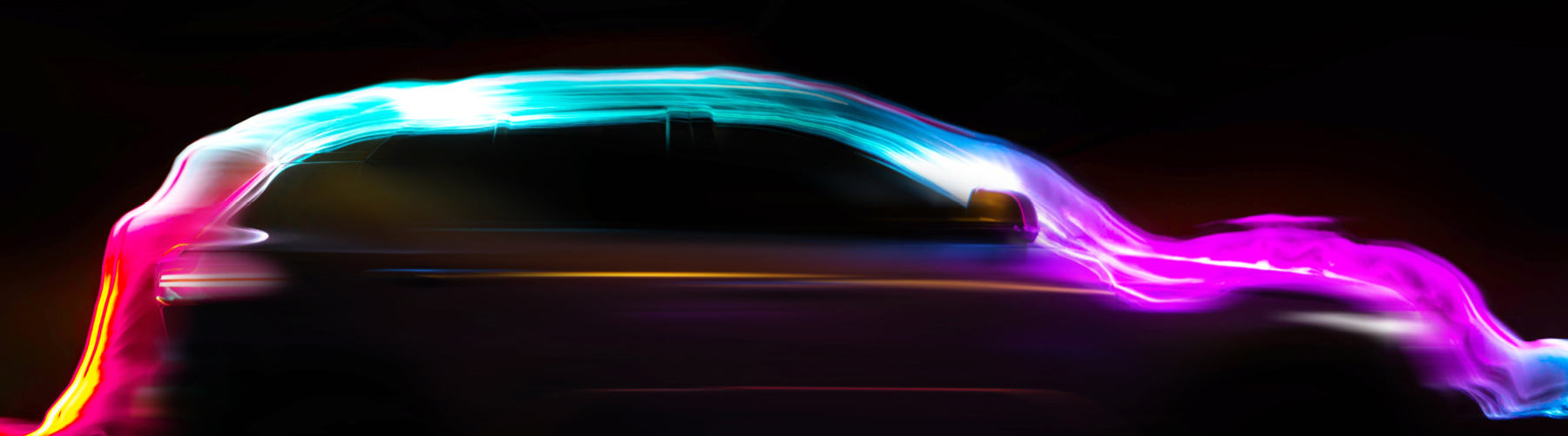 Blurred vehicle with coloured lights streaming over the vehicle