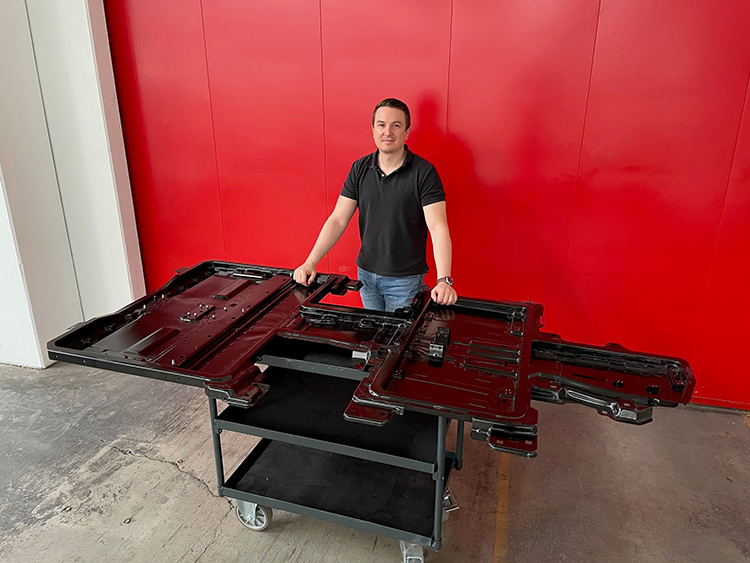 Gregor Klement standing behind a battery enclosure.