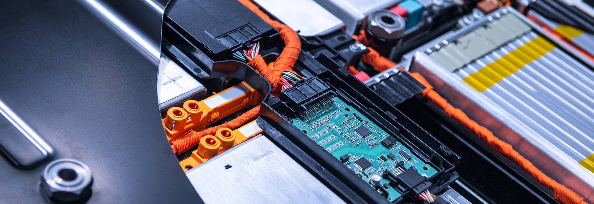 Close-up of an electric vehicle battery pack with visible wiring and components