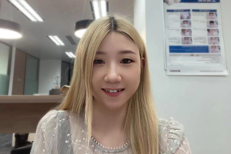 Anna Cao sitting at her desk at her office