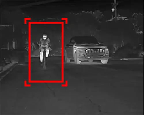 Person riding a bike at night being detected by sensor from a car